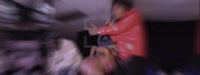 a blurry image of a man in a red jacket